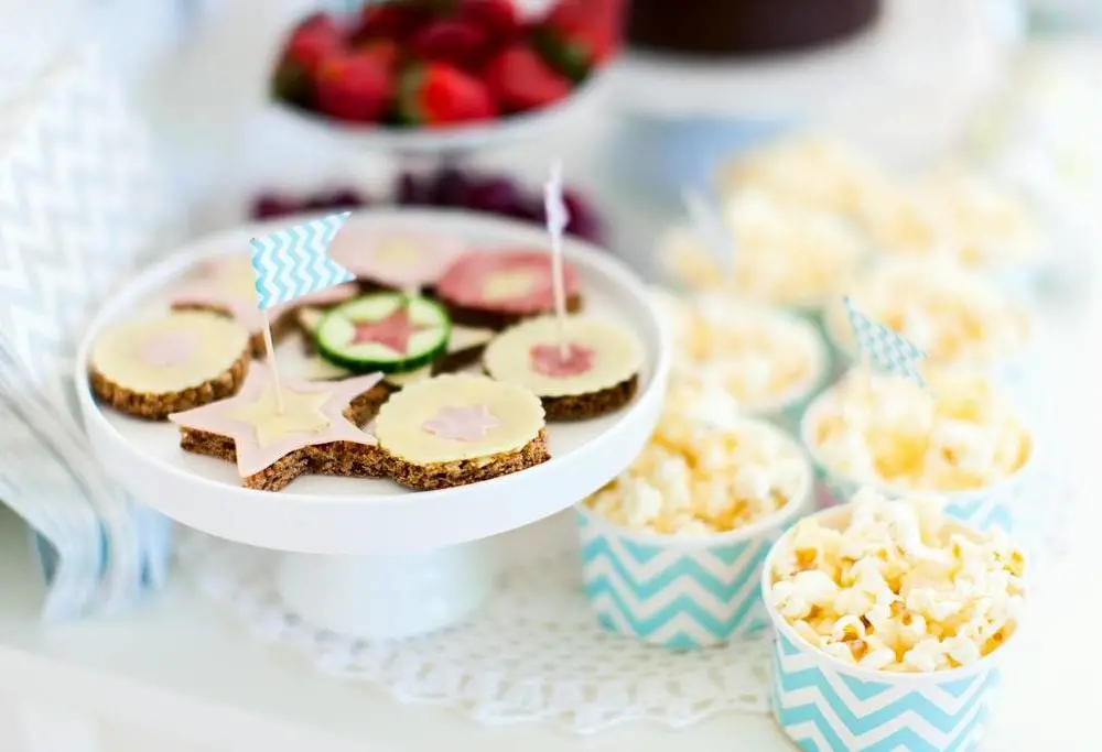 Berries, popcorn and canape selection at party table