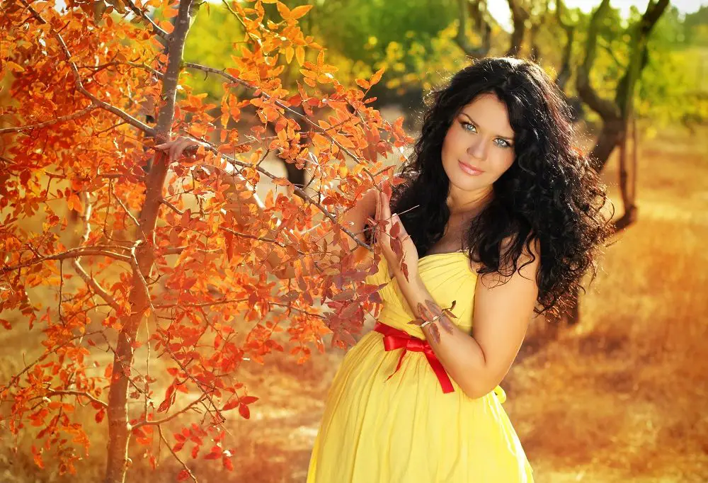 Beautiful Pregnant Woman Relaxing Outside In The Park, Autumn